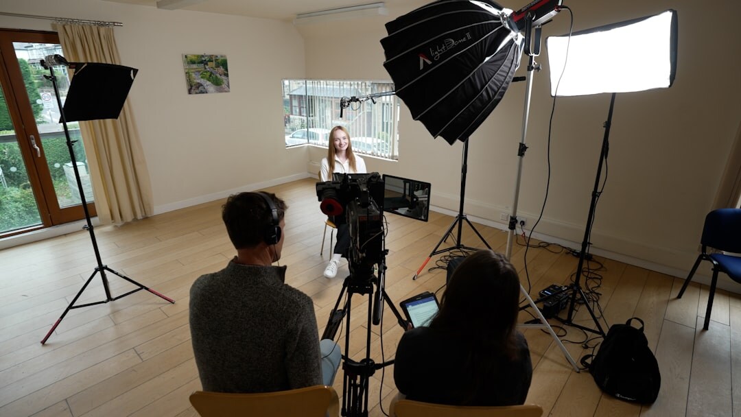 Professional camera operator filming in a TV studio with broadcast equipment