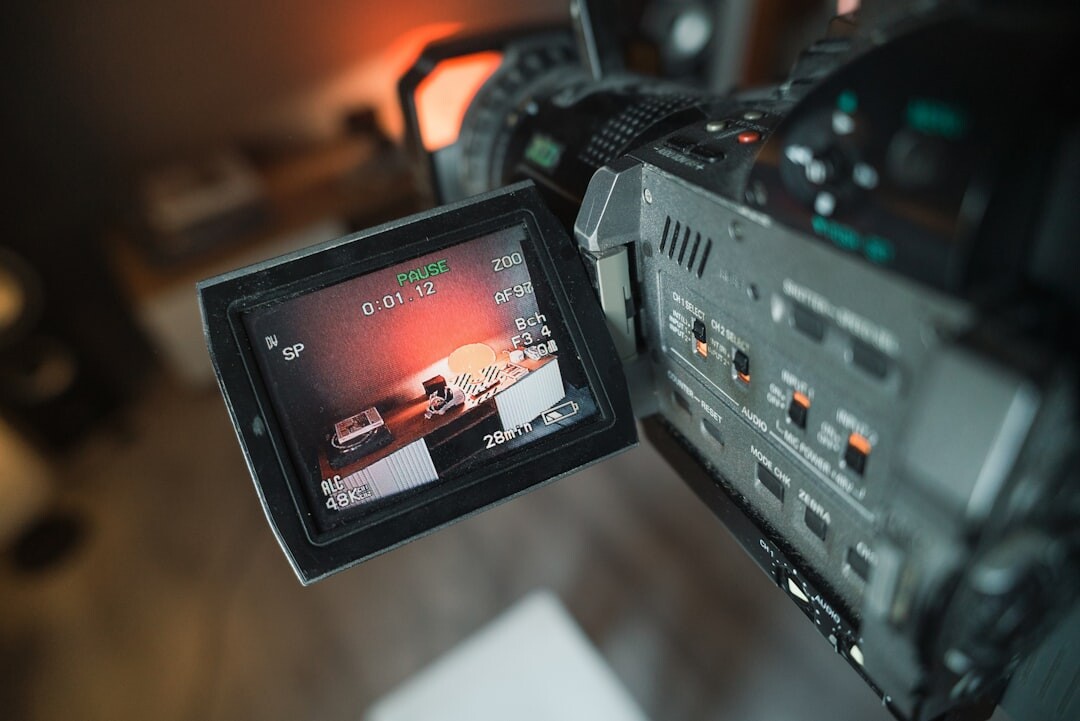 Close-up of a professional broadcast camera with controls and settings